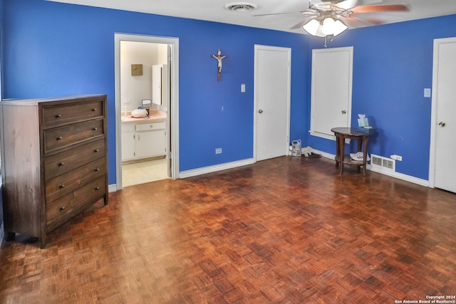 unfurnished bedroom with dark parquet floors, ceiling fan, and ensuite bathroom