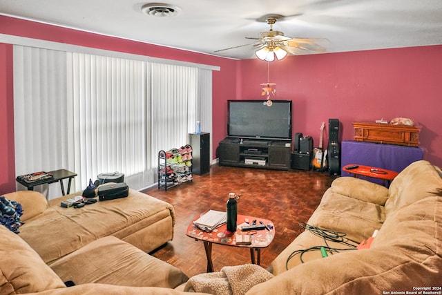 living room featuring dark hardwood / wood-style floors, ceiling fan, and a wealth of natural light