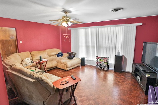 living room with dark parquet floors and ceiling fan