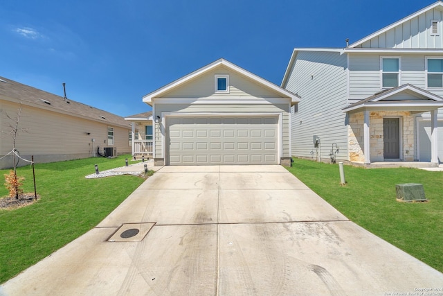 view of front of property with a front yard, cooling unit, and a garage