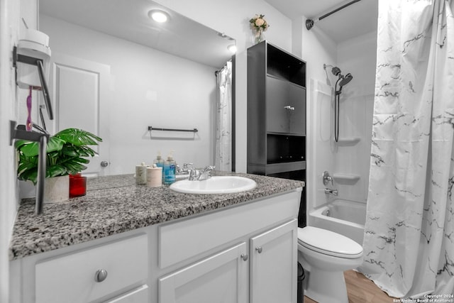 full bathroom with vanity, hardwood / wood-style floors, toilet, and shower / tub combo with curtain