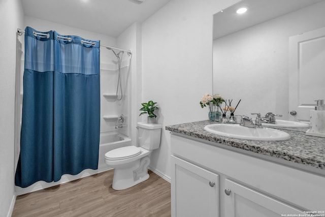 full bathroom with vanity, toilet, hardwood / wood-style flooring, and shower / bath combo