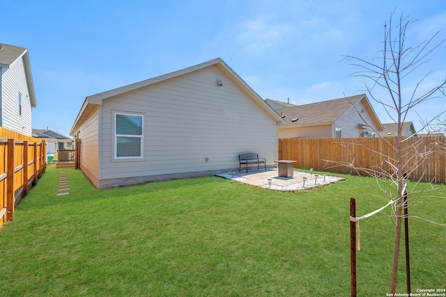 back of property with a lawn and a patio area