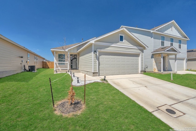 view of front of home featuring central AC unit, a front yard, and a garage