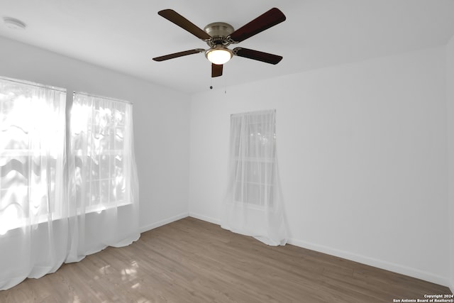 spare room with hardwood / wood-style floors and ceiling fan