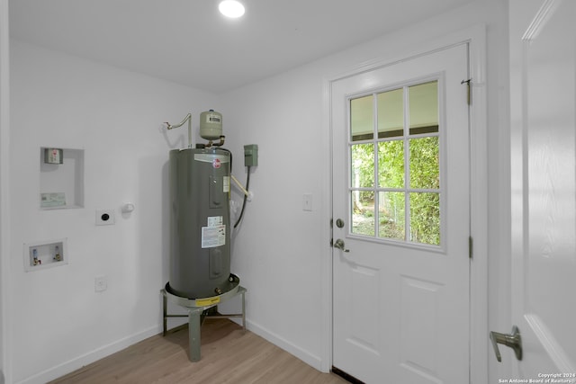 interior space featuring electric water heater and light wood-type flooring