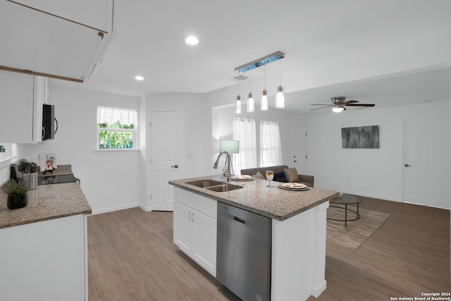 kitchen featuring appliances with stainless steel finishes, hanging light fixtures, light hardwood / wood-style floors, white cabinetry, and a kitchen island with sink