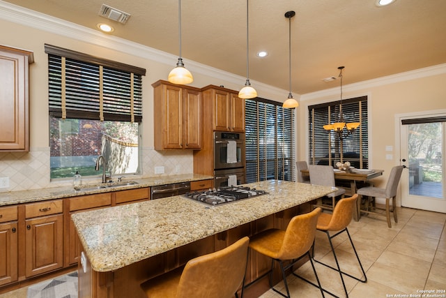 kitchen featuring decorative backsplash, a center island, appliances with stainless steel finishes, and ornamental molding