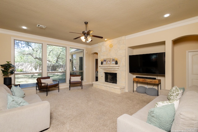 living room with light carpet, ornamental molding, a textured ceiling, and ceiling fan