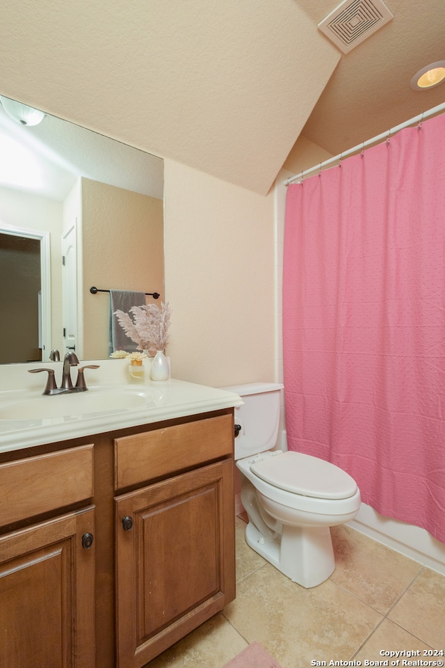 full bathroom with shower / tub combo, tile patterned flooring, vanity, and toilet