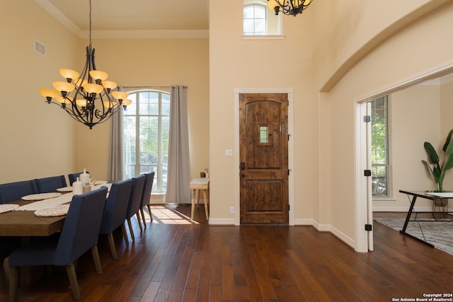 dining space featuring a notable chandelier, dark hardwood / wood-style floors, a healthy amount of sunlight, and crown molding