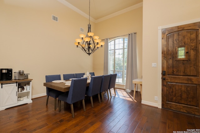 dining room with an inviting chandelier, dark wood-type flooring, and crown molding