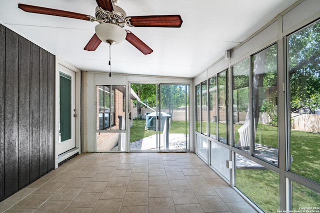 unfurnished sunroom with ceiling fan and vaulted ceiling