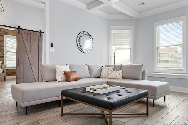 living room with coffered ceiling, light wood-type flooring, a barn door, and a wealth of natural light