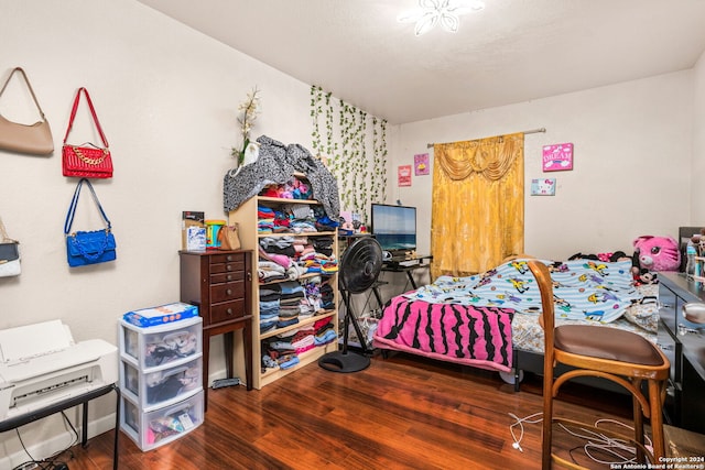 bedroom with dark wood-type flooring