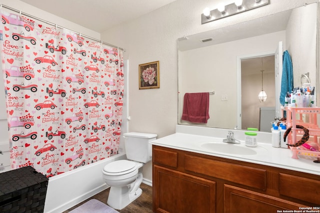 full bathroom with toilet, hardwood / wood-style floors, shower / bath combo with shower curtain, and vanity