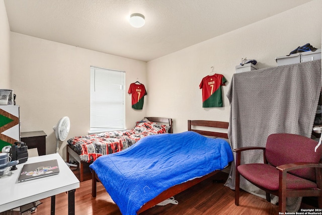 bedroom with hardwood / wood-style floors