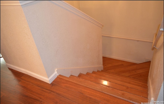 stairs featuring hardwood / wood-style floors