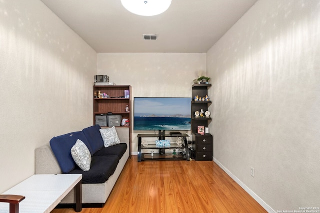 living area with hardwood / wood-style flooring