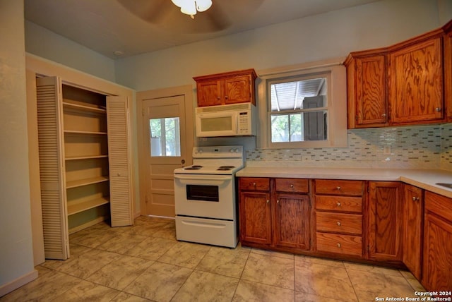 kitchen featuring white appliances, ceiling fan, and backsplash