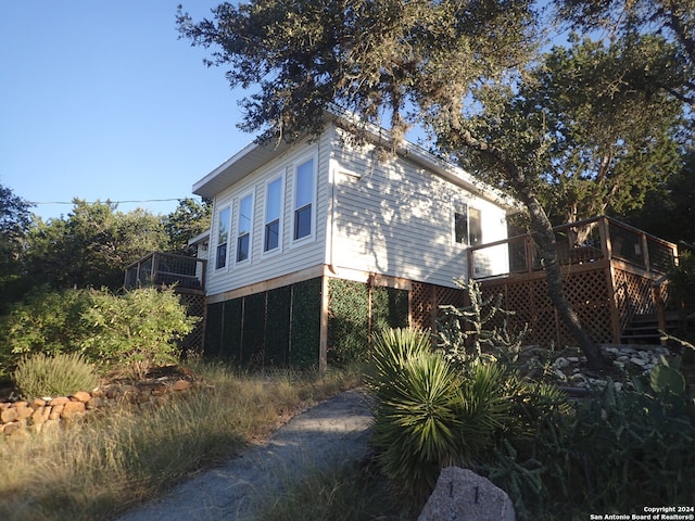 view of property exterior with a deck