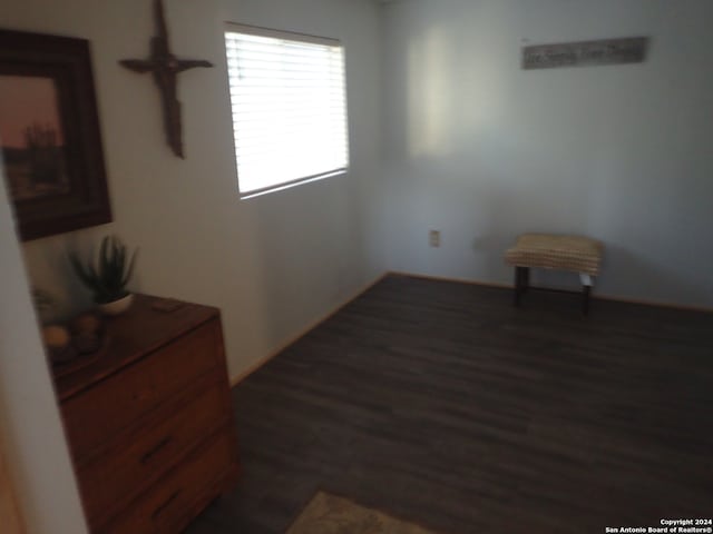 unfurnished room with dark hardwood / wood-style flooring