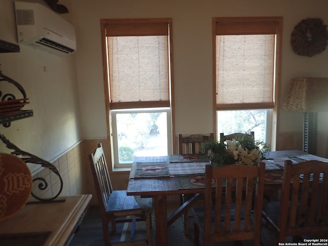 dining area featuring an AC wall unit