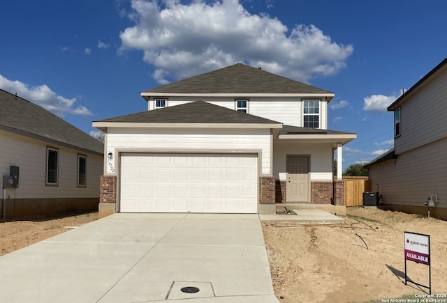 view of front of home featuring a garage and central air condition unit