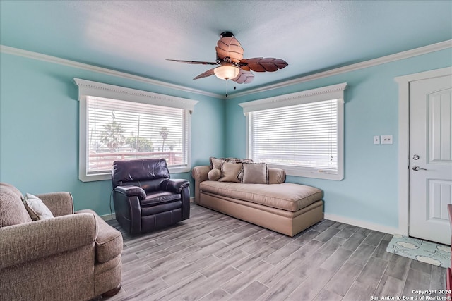 living room with ceiling fan, light wood-type flooring, and crown molding