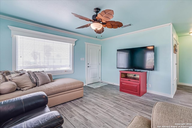 living room featuring ceiling fan, light wood-type flooring, and crown molding