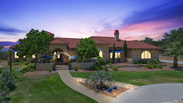 mediterranean / spanish-style house featuring a yard