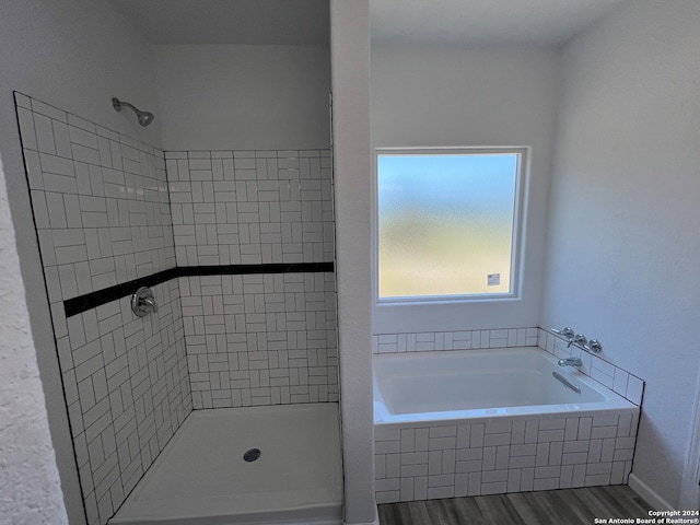 bathroom featuring independent shower and bath and hardwood / wood-style floors