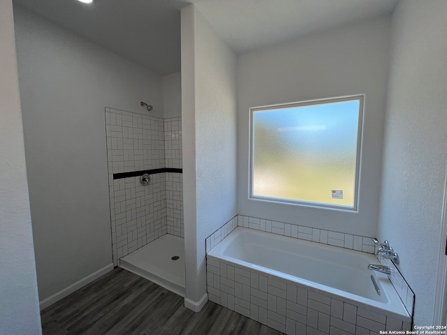 bathroom with plus walk in shower and wood-type flooring