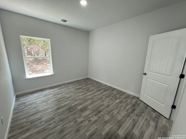 empty room with dark hardwood / wood-style floors