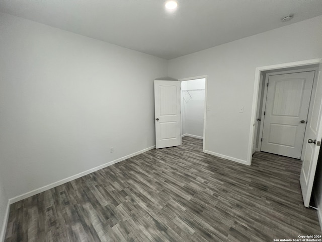 unfurnished bedroom with dark hardwood / wood-style floors