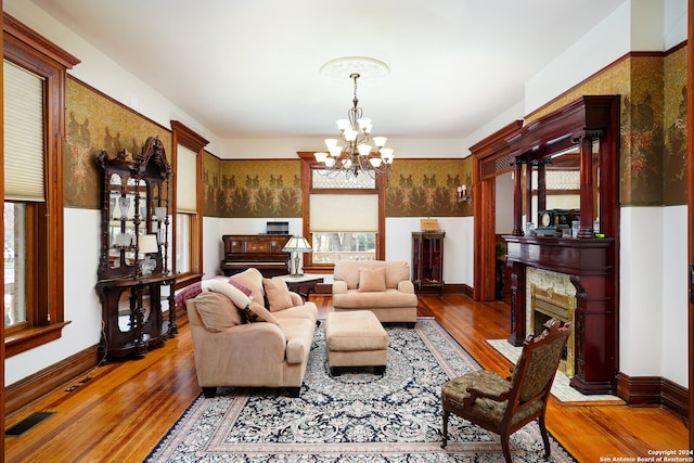 living room with hardwood / wood-style flooring and a notable chandelier