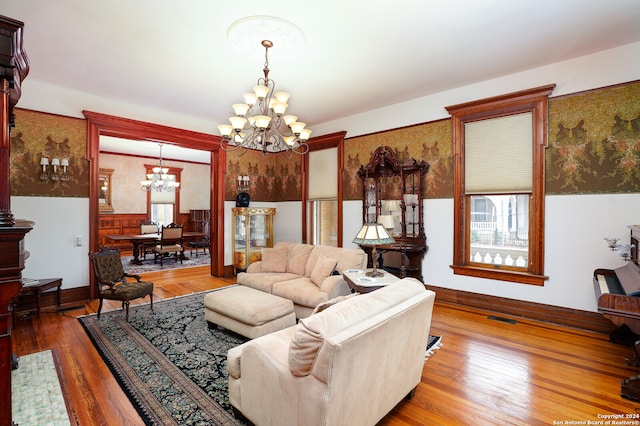 living room with hardwood / wood-style floors and a notable chandelier