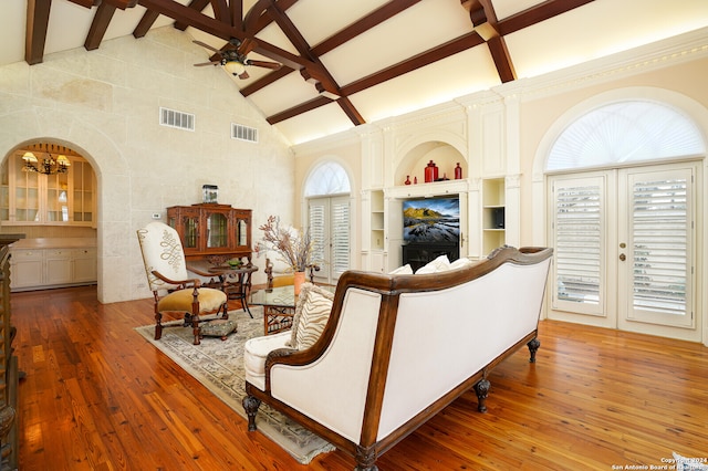 living room with ceiling fan, hardwood / wood-style floors, and beam ceiling