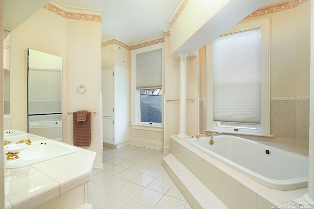 bathroom with sink, tile patterned floors, crown molding, tiled bath, and ornate columns