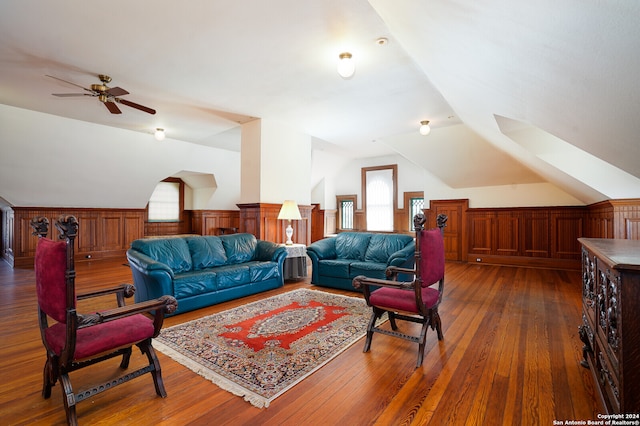 living room with lofted ceiling, dark hardwood / wood-style flooring, and ceiling fan