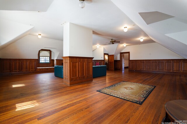 additional living space with vaulted ceiling, ceiling fan, and dark wood-type flooring