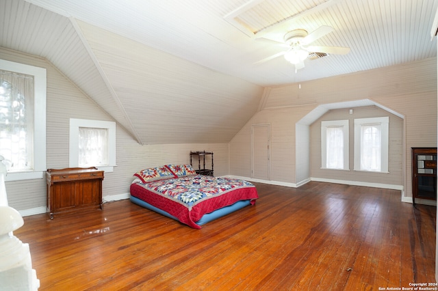 bedroom with ceiling fan, hardwood / wood-style flooring, and vaulted ceiling