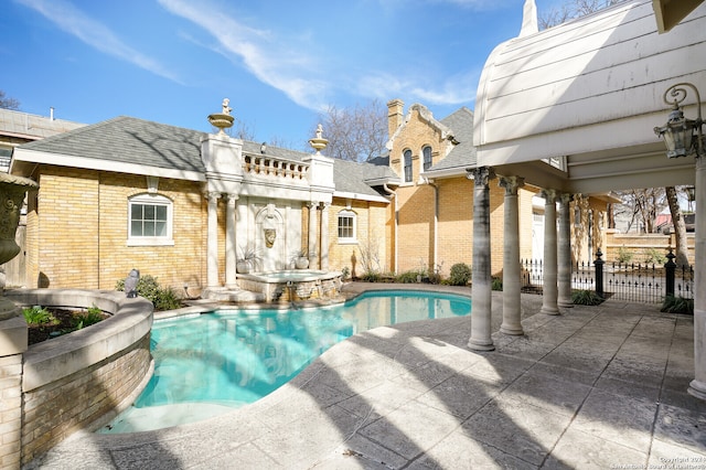 view of pool featuring a patio and an in ground hot tub