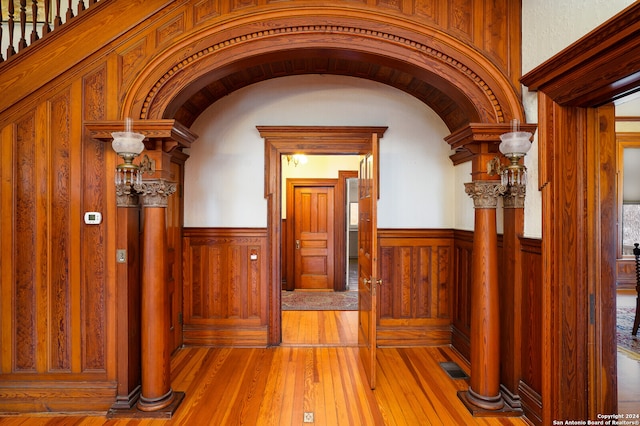 hallway with wood walls and hardwood / wood-style flooring