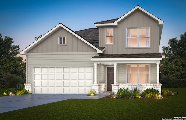 view of front of house featuring a garage and a front lawn