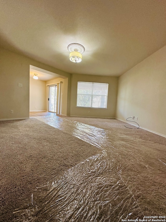 unfurnished room featuring a textured ceiling