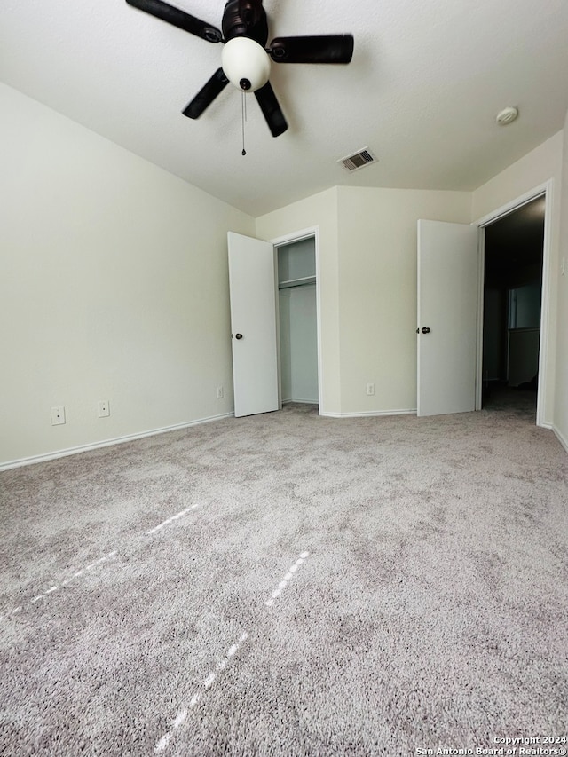 unfurnished bedroom featuring carpet and ceiling fan