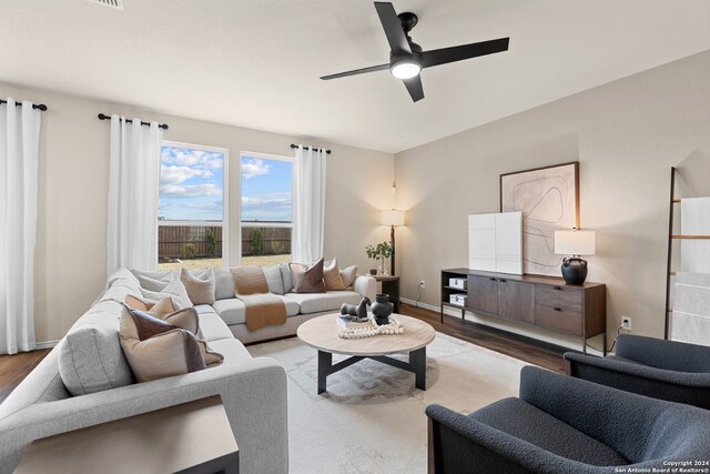 living room with dark hardwood / wood-style floors and ceiling fan