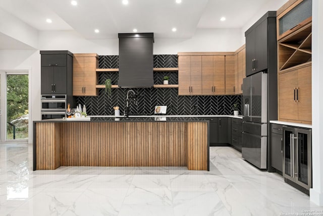 kitchen with tasteful backsplash, a kitchen island, stainless steel appliances, beverage cooler, and extractor fan