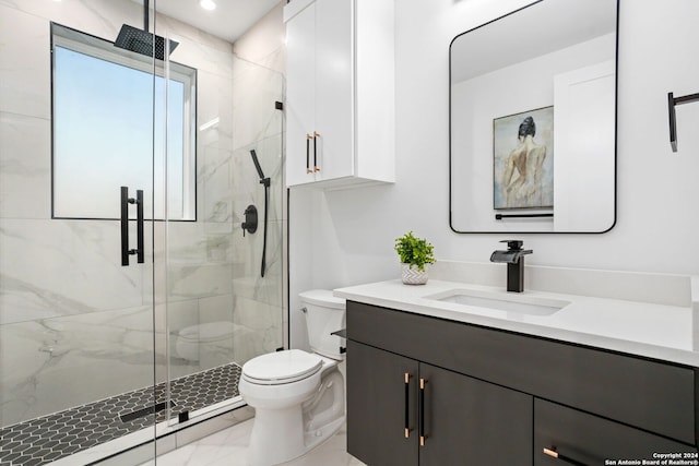 bathroom with walk in shower, vanity, and toilet